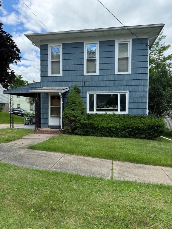 front facade with a front lawn