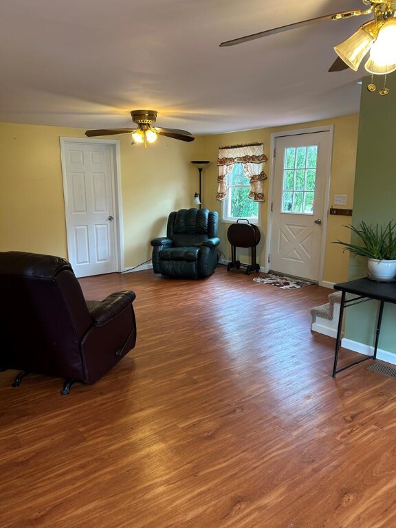 living room with hardwood / wood-style floors and ceiling fan