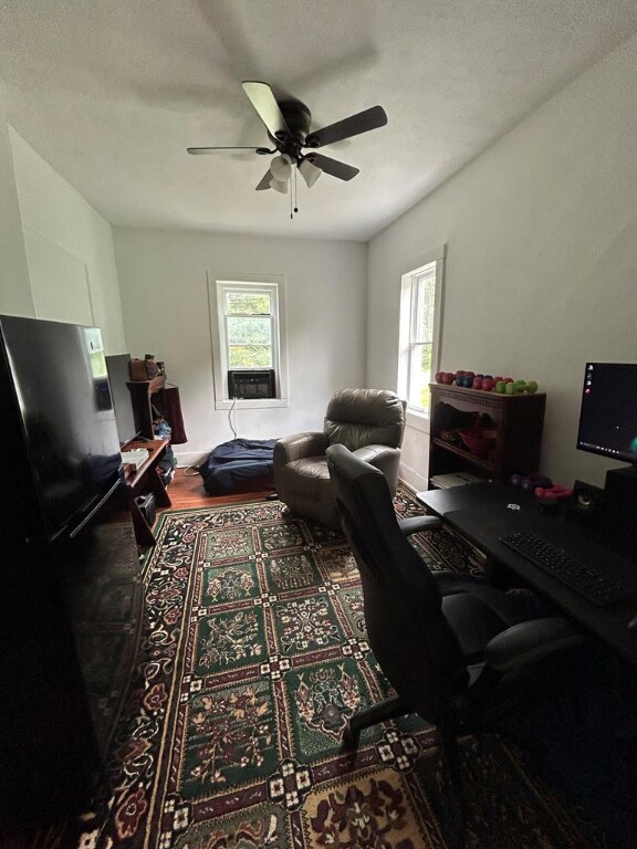 home office with a textured ceiling, a wealth of natural light, and ceiling fan