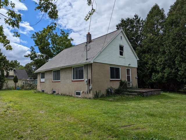 rear view of house featuring a yard