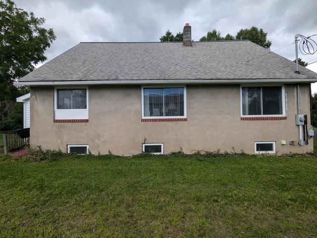 rear view of house featuring a yard