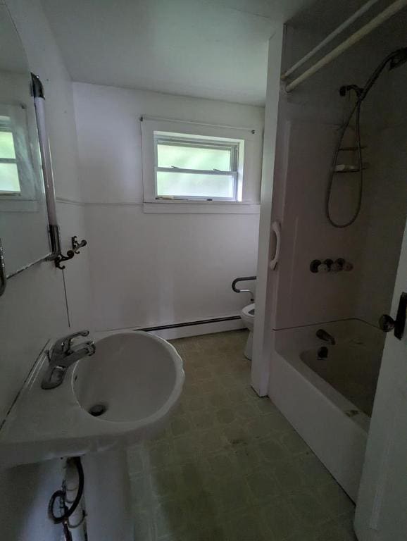 full bathroom with bathing tub / shower combination, sink, baseboard heating, and toilet