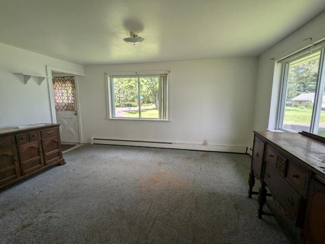 unfurnished bedroom featuring multiple windows, a baseboard radiator, and light colored carpet