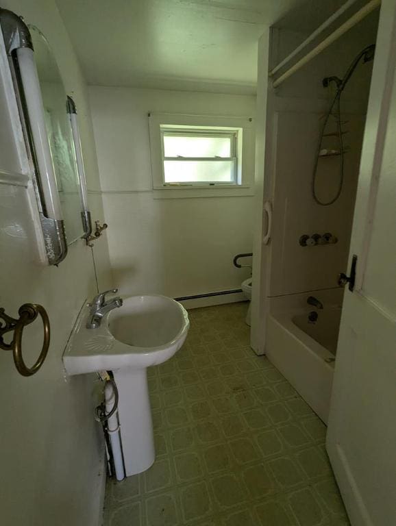 bathroom with a baseboard heating unit, toilet, and shower / bath combination