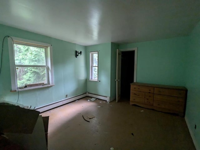 bedroom with multiple windows and a baseboard heating unit