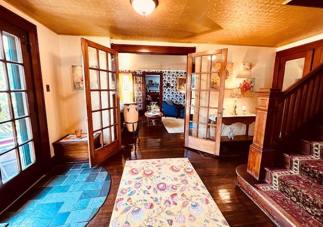 interior space featuring dark hardwood / wood-style floors, french doors, and a textured ceiling