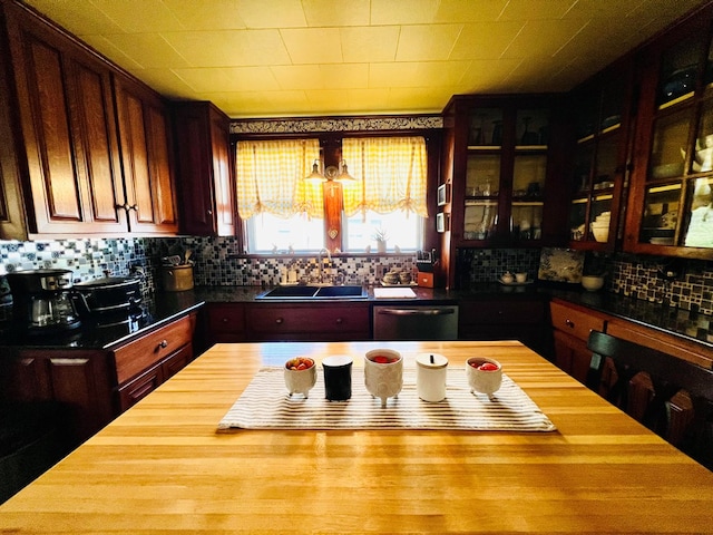 kitchen with dishwasher, backsplash, and sink