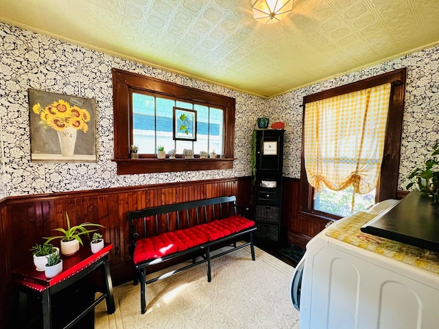 bedroom featuring multiple windows and wooden walls