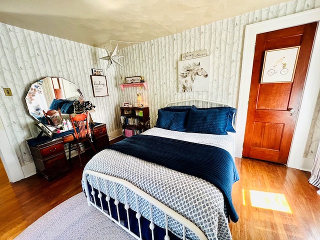 bedroom with hardwood / wood-style floors