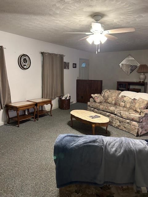 carpeted living room with ceiling fan and a textured ceiling