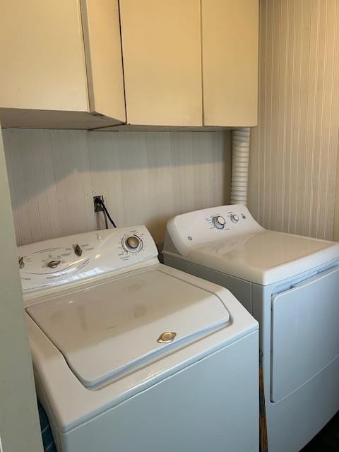 laundry room featuring cabinets and washing machine and dryer