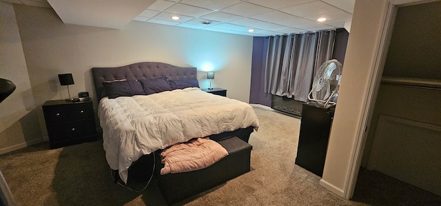 carpeted bedroom featuring a paneled ceiling