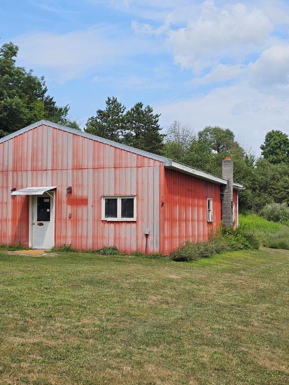 view of outbuilding with a yard