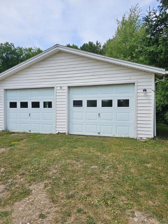 garage with a lawn