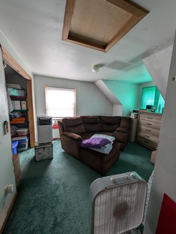 living room featuring dark colored carpet