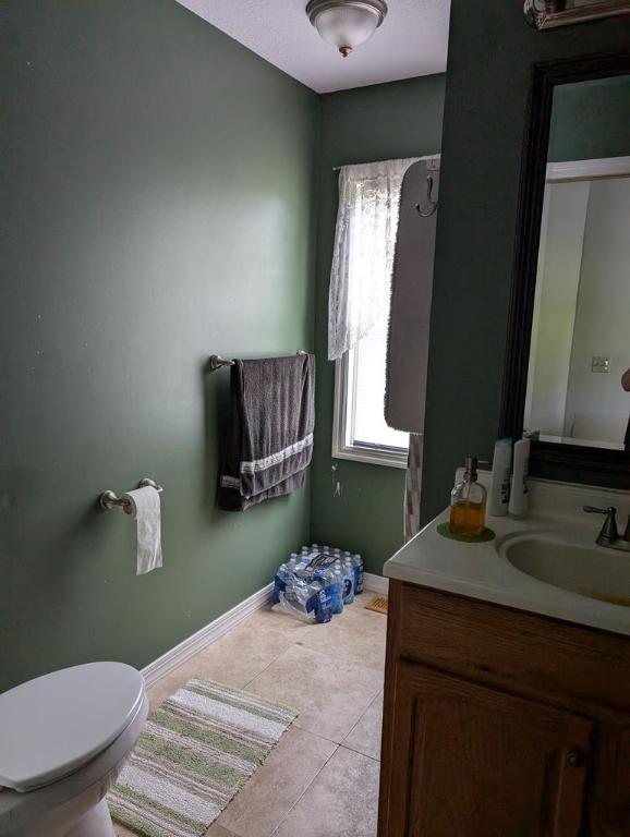 bathroom featuring tile patterned floors, toilet, and vanity