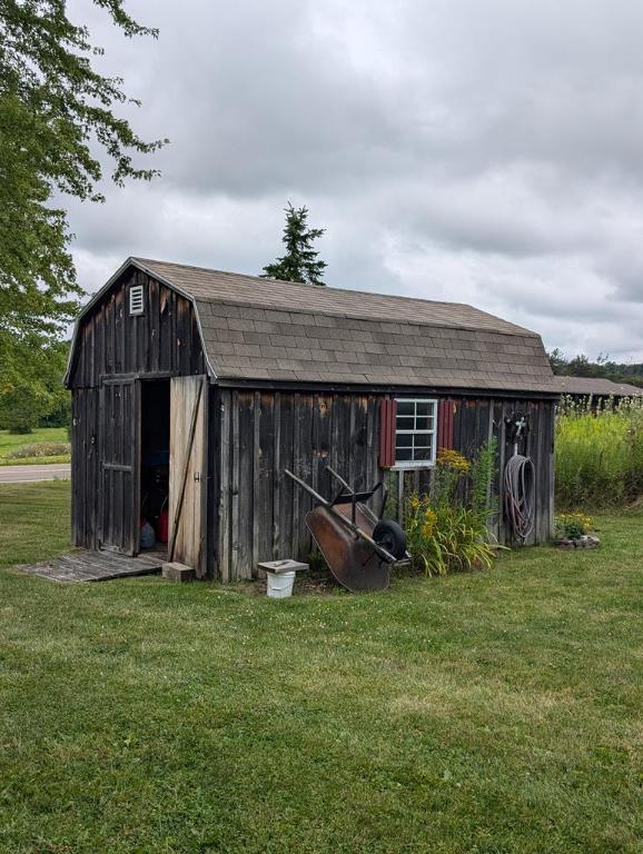 view of outbuilding with a yard