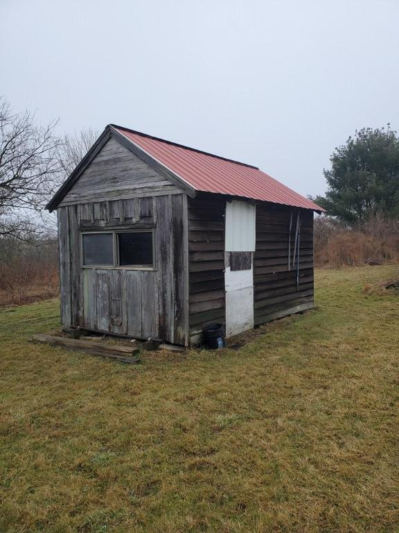 view of outbuilding featuring a yard