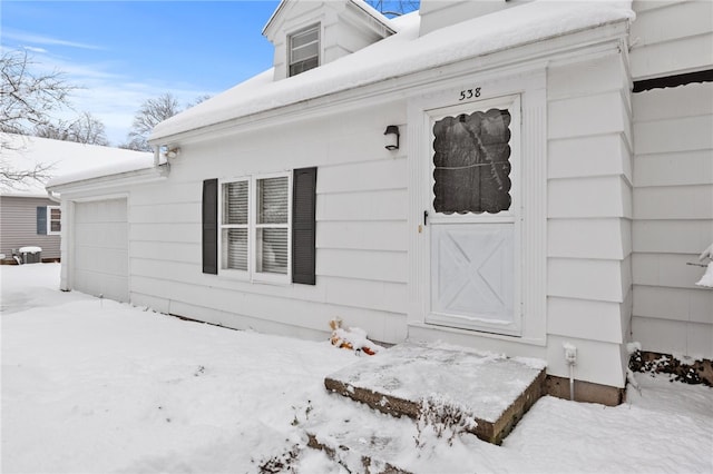 view of snow covered property entrance