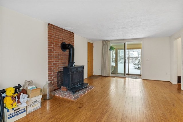 living room with hardwood / wood-style flooring and a wood stove