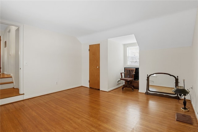 interior space featuring vaulted ceiling and hardwood / wood-style floors