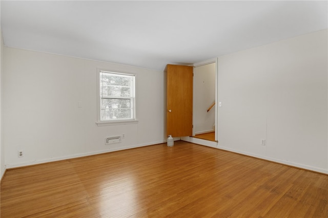 unfurnished room featuring hardwood / wood-style floors