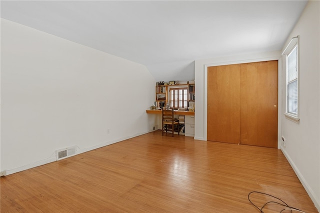 interior space with vaulted ceiling and light wood-type flooring