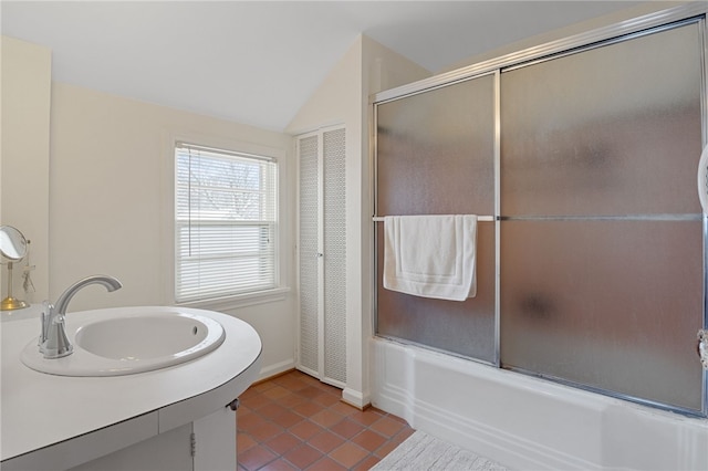 bathroom with tile patterned flooring, vaulted ceiling, vanity, and bath / shower combo with glass door