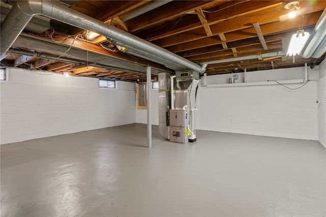 basement featuring electric panel and heating unit