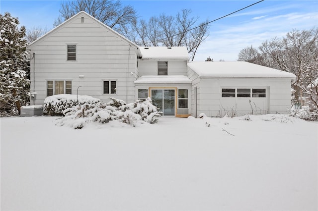 snow covered house with a garage