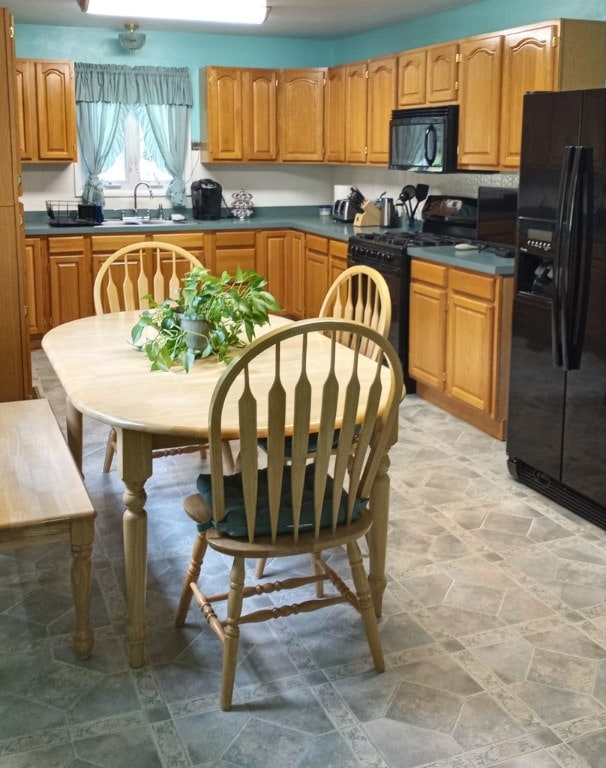 kitchen with sink and black appliances