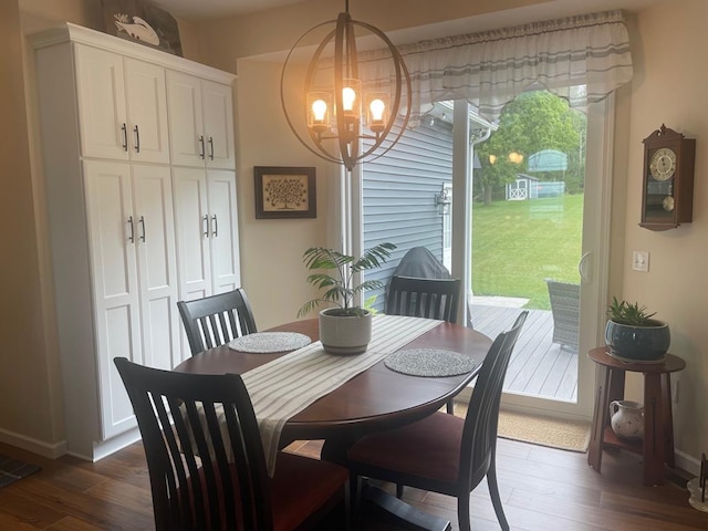 dining room with dark hardwood / wood-style flooring, a wealth of natural light, and an inviting chandelier