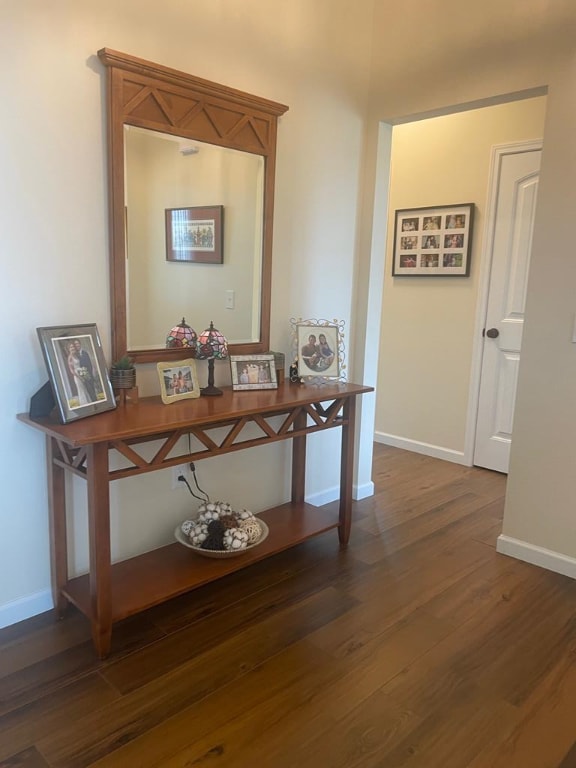 corridor with dark hardwood / wood-style floors