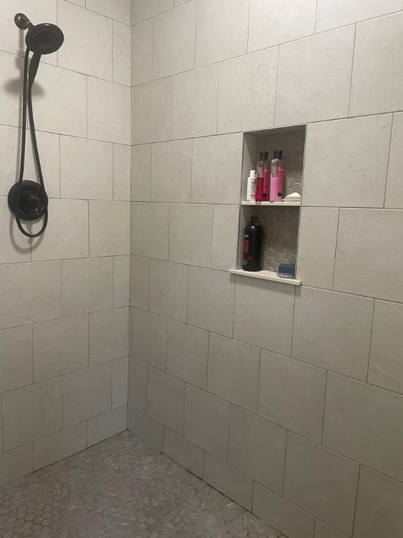 bathroom with tiled shower