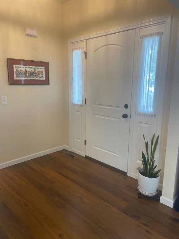 foyer entrance with dark hardwood / wood-style floors