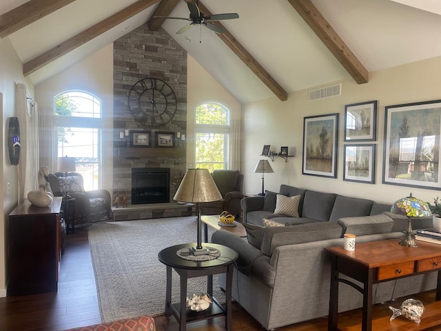 living room with a stone fireplace, high vaulted ceiling, dark hardwood / wood-style flooring, beamed ceiling, and ceiling fan