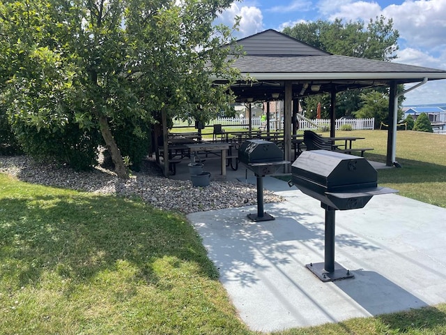 view of property's community with a yard, a gazebo, and a patio area