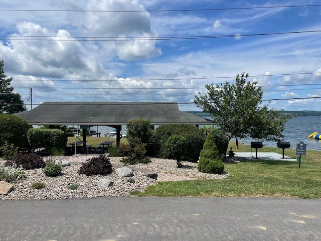 exterior space featuring a water view and a yard