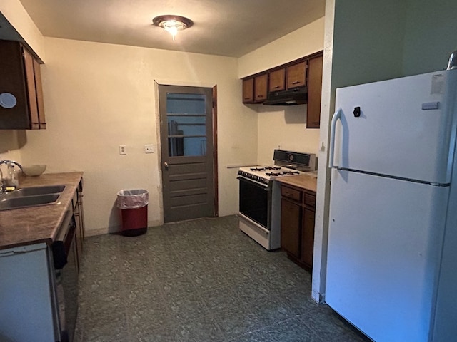 kitchen featuring dark brown cabinets, sink, and white appliances