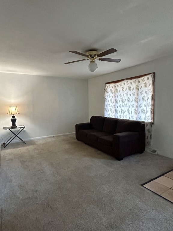 unfurnished living room featuring carpet flooring and ceiling fan