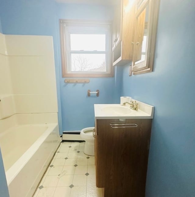 bathroom with vanity, a baseboard heating unit, and toilet