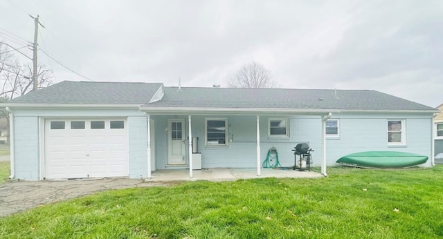 view of front of home featuring a garage and a front lawn