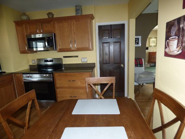 kitchen featuring hardwood / wood-style floors and appliances with stainless steel finishes