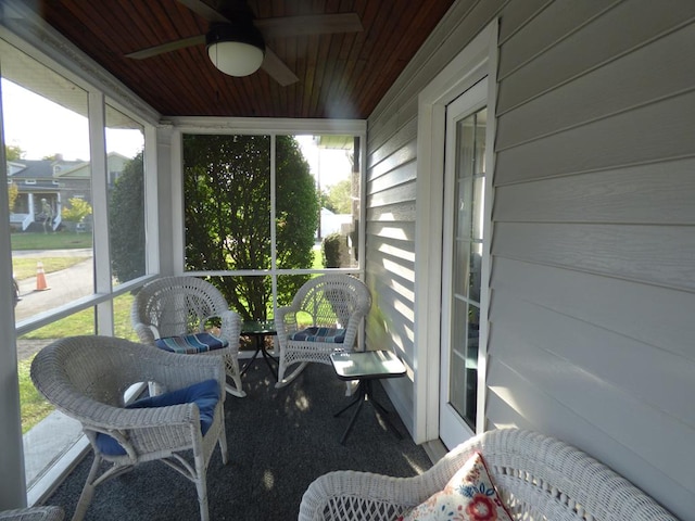 sunroom / solarium featuring wooden ceiling and ceiling fan