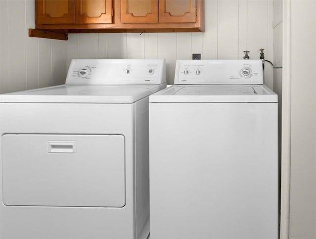 laundry area featuring cabinets and washing machine and dryer