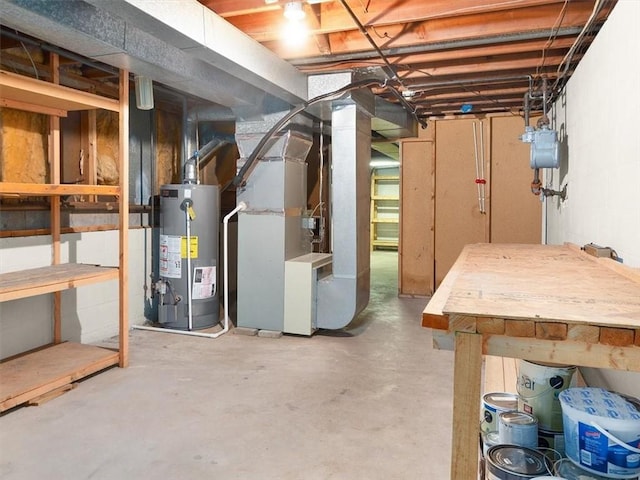 basement featuring heating unit and water heater