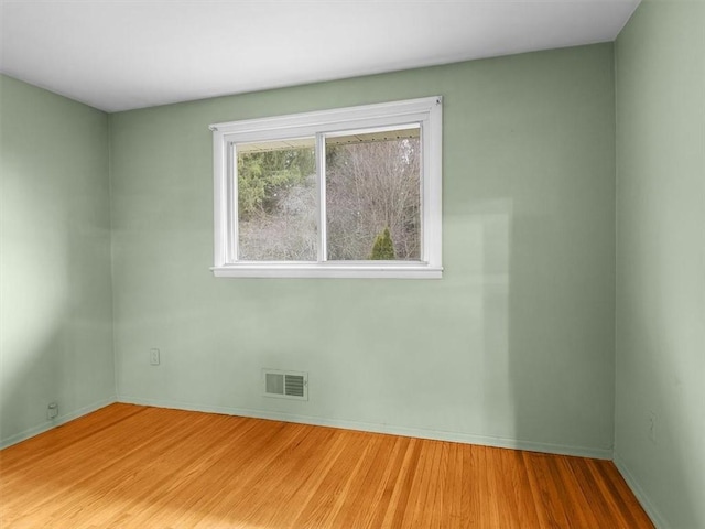 spare room with wood-type flooring