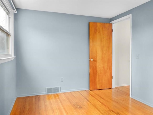 empty room with wood-type flooring