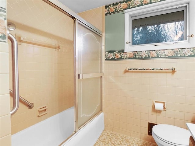 full bathroom featuring tile walls, tile patterned flooring, enclosed tub / shower combo, vanity, and toilet