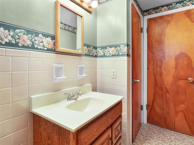 bathroom featuring vanity and tile walls